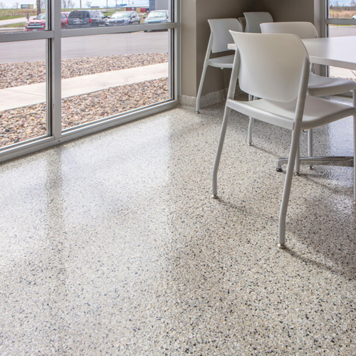 cafeteria area with multi-colored epoxy floor coating and chairs and table