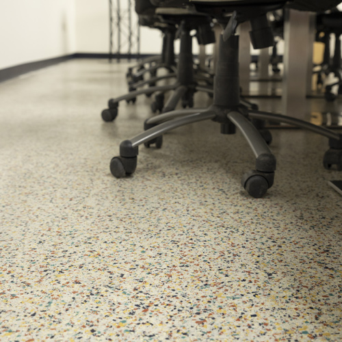 upcloe view of office chairs with multi-colored flaked floor coating