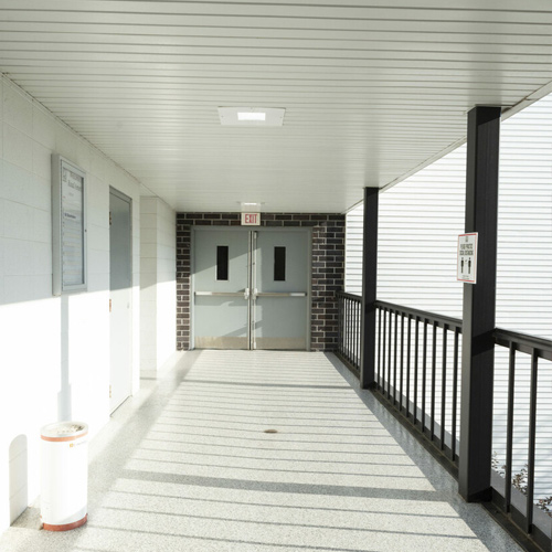 walkway of commercial property with gray flaked epoxy floor coating