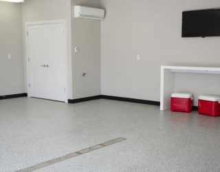 garage with coolers and gray flaked epoxy floor coating