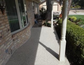 brick home with patio floor coating